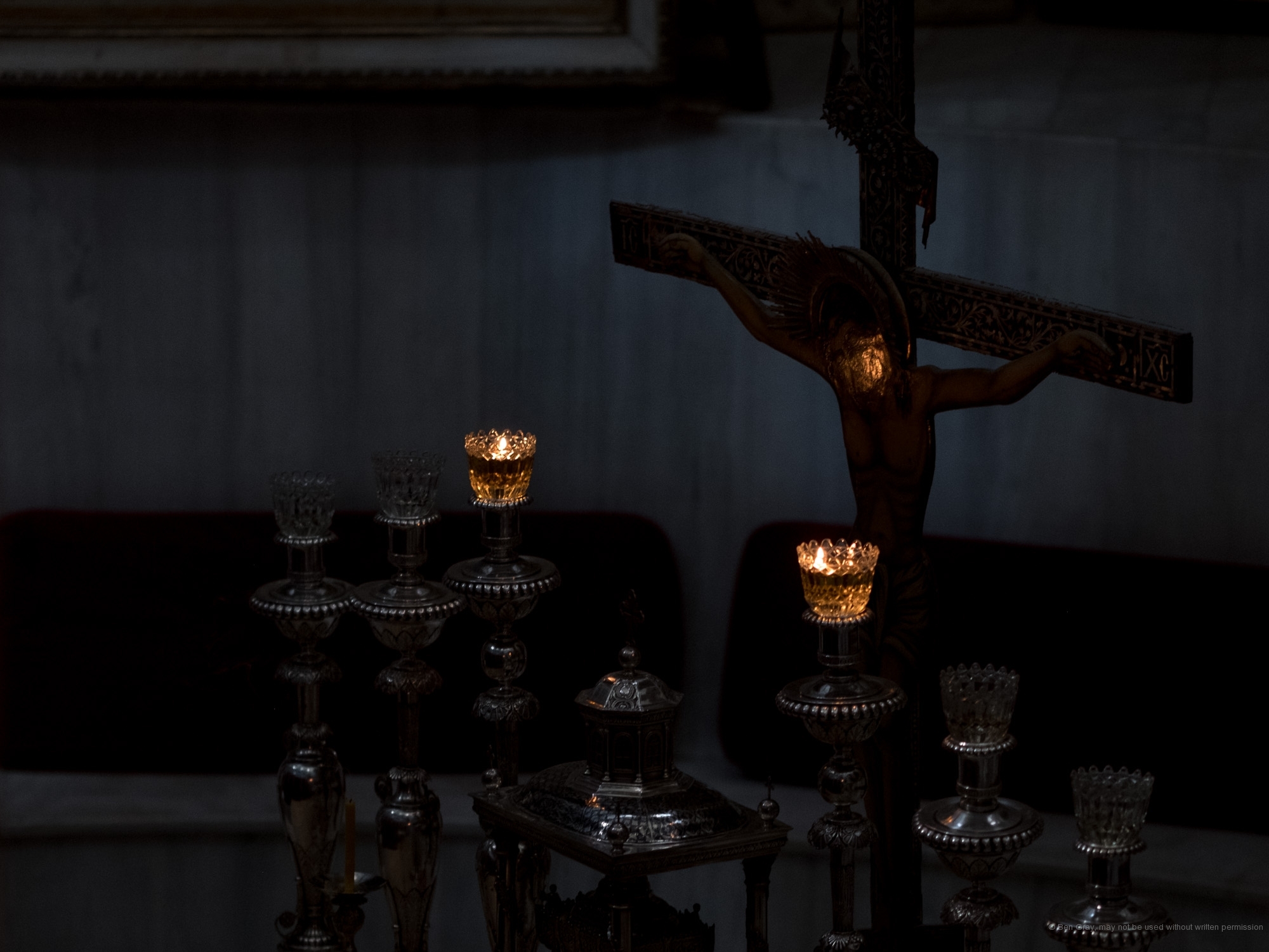 Oil lamps light up a crucifix in the sanctuary of the Greek Orthodox church inside the Church of the Holy Sepulchre.