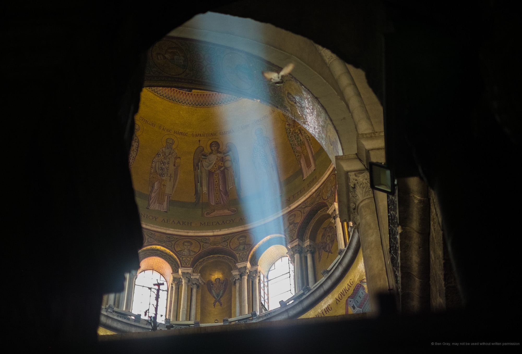 A beam of light shines through a window in the Church of the Holy Sepulchre's dome.