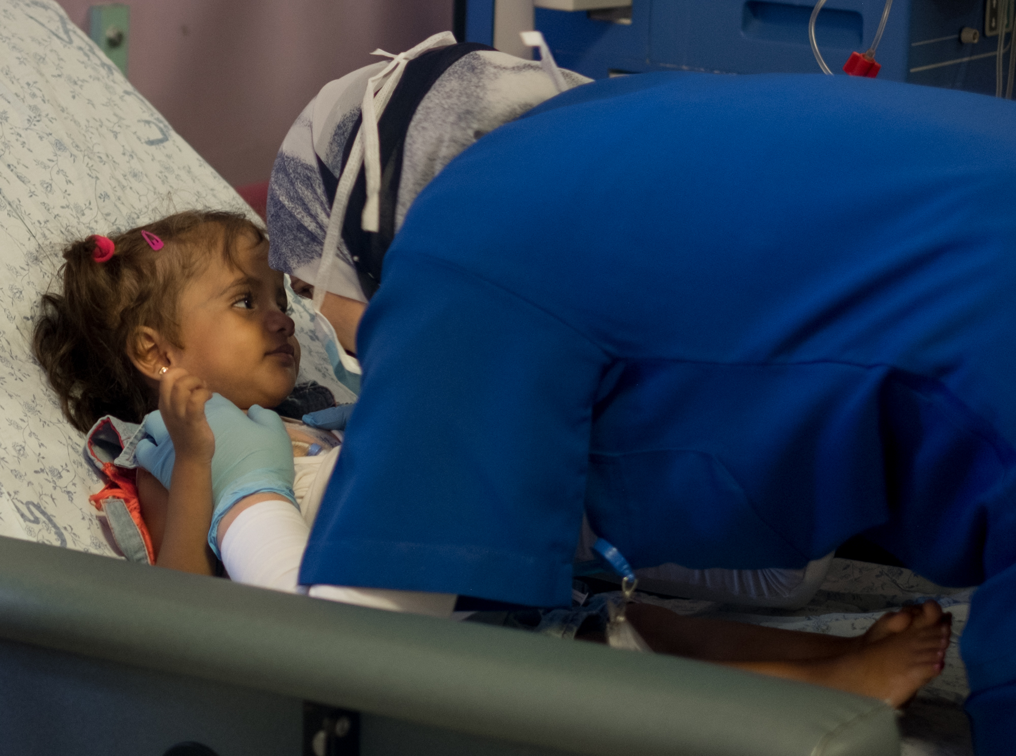 Ritaj, 5, a hemodialysis patient from Bethlehem in the West Bank, looks into her nurse's eyes while undergoing treatment at The Lutheran World Federation's Augusta Victoria Hospital (AVH) in East Jerusalem on Saturday morning, 8 September, 2018. AVH is the only hospital that offers pediatric hemodialysis for Palestinians from the West Bank and Gaza. Photo by Ben Gray / LWF