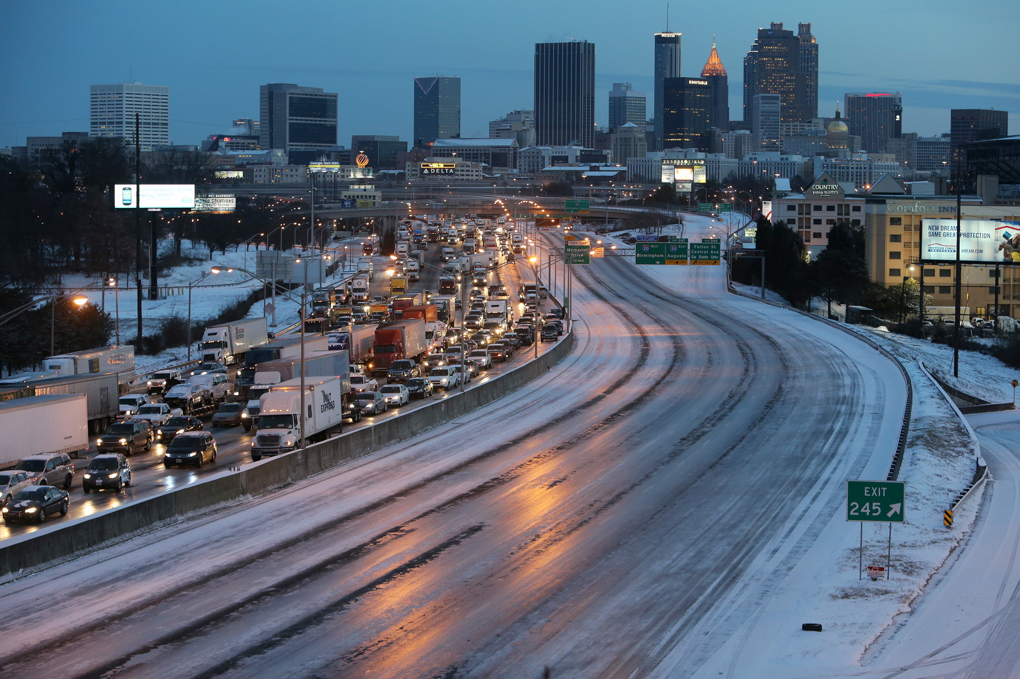 As dawn breaks following the first winter storm of the 2014, the Connector Southbound is clogged with cars and trucks that were stuck overnight while trying to leave Downtown Atlanta.