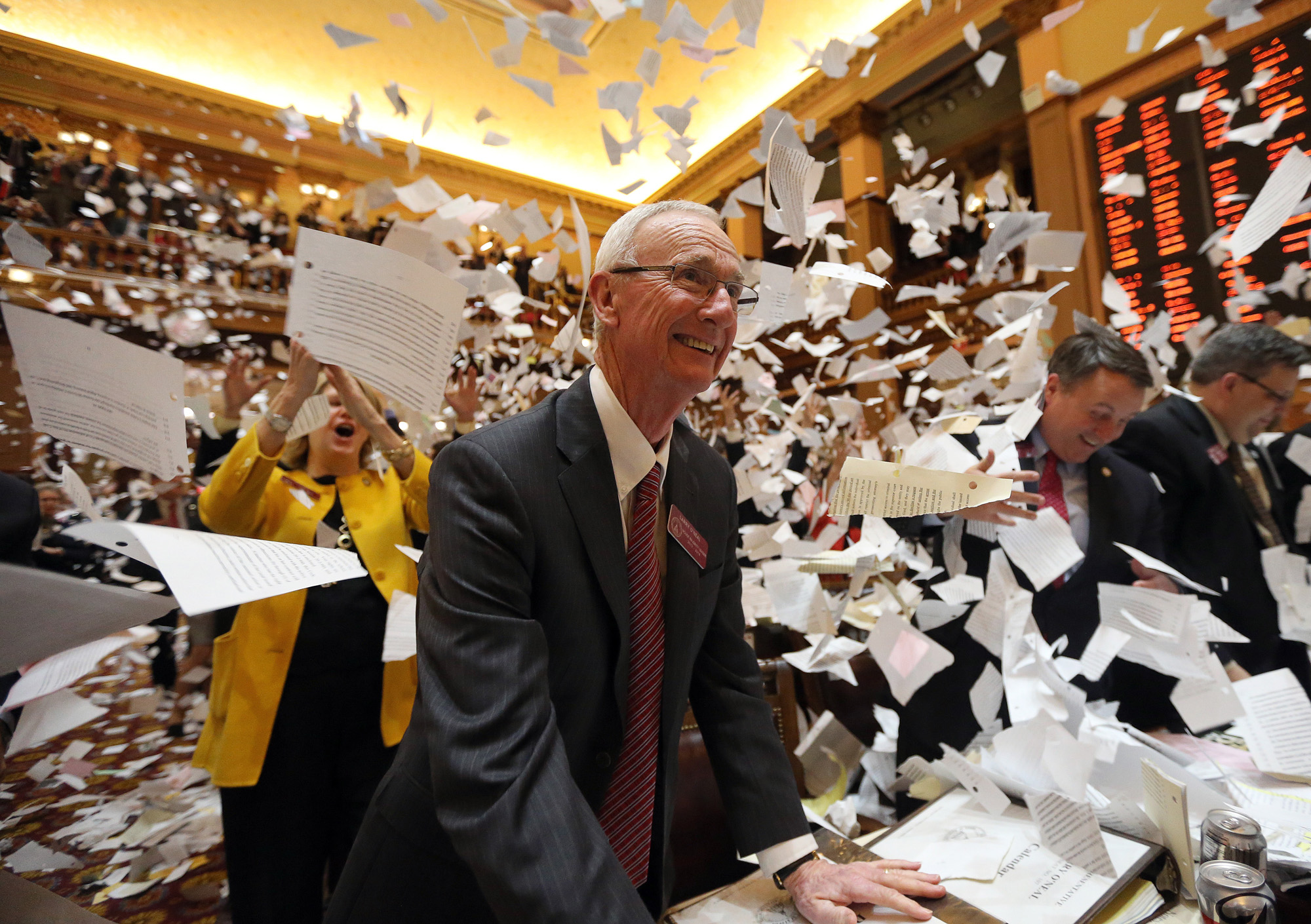 House Majority Leader Larry O'Neal is all smiles as papers fly through the air just after midnight when the 2014 Legislative session comes to a close. In an annual tradition, Legislators celebrate the end of the session with their own version of confetti made from printed copies of bills and resolutions.