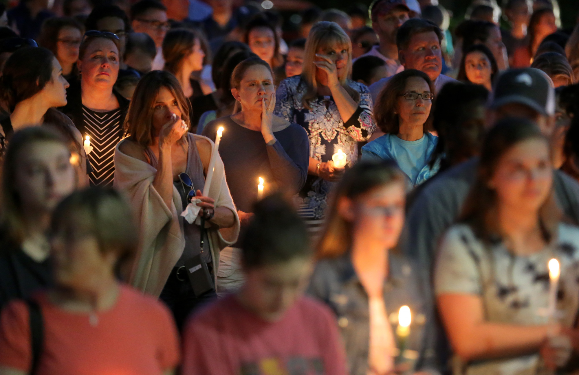 Friends of the UGA students who died in a car crash Wednesday night grieve during a vigil at Milton High School.