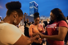 Marietta resident Valerie Ward, from left, and her daughters Rochelle Ward and Jasmine Ward hold hands in prayer at the end of the “Respect Black Life: I Am Trayvon Martin” march and rally. More than 1,000 people turned out for the protest that started in the West End and ended at CNN Center.