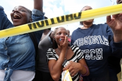 Relatives including Misty Henderson, center, are overcome as the buses with their loved-ones pull into the parking lot at Walmart to be reunited with them after shots were fired at McNair Discovery Learning Academy and the school was evacuated. Henderson had two grandchildren at the school at the time.