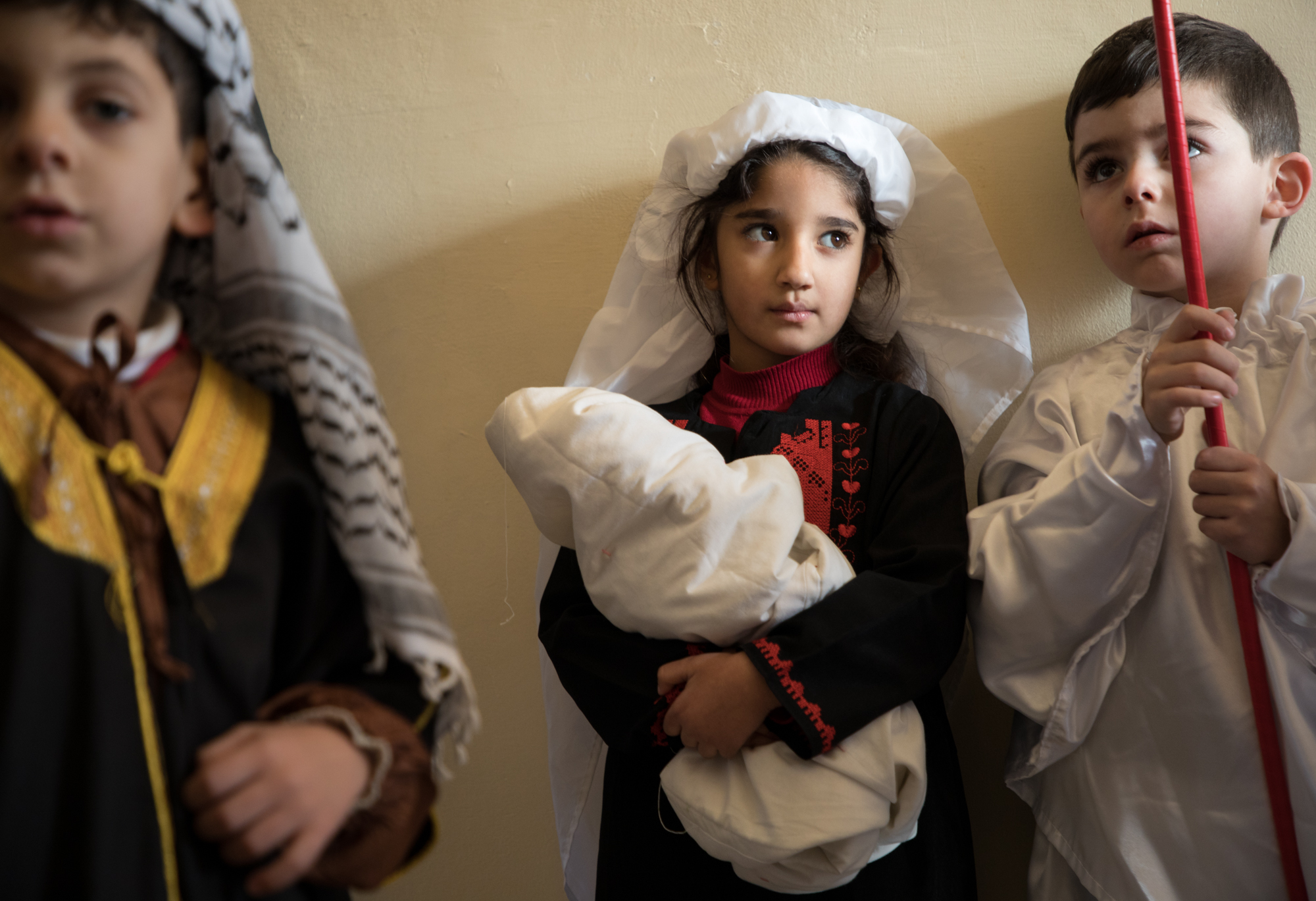 Palestinian children wait for their part in the Christmas pageant at the Lutheran school in Beit Jala.