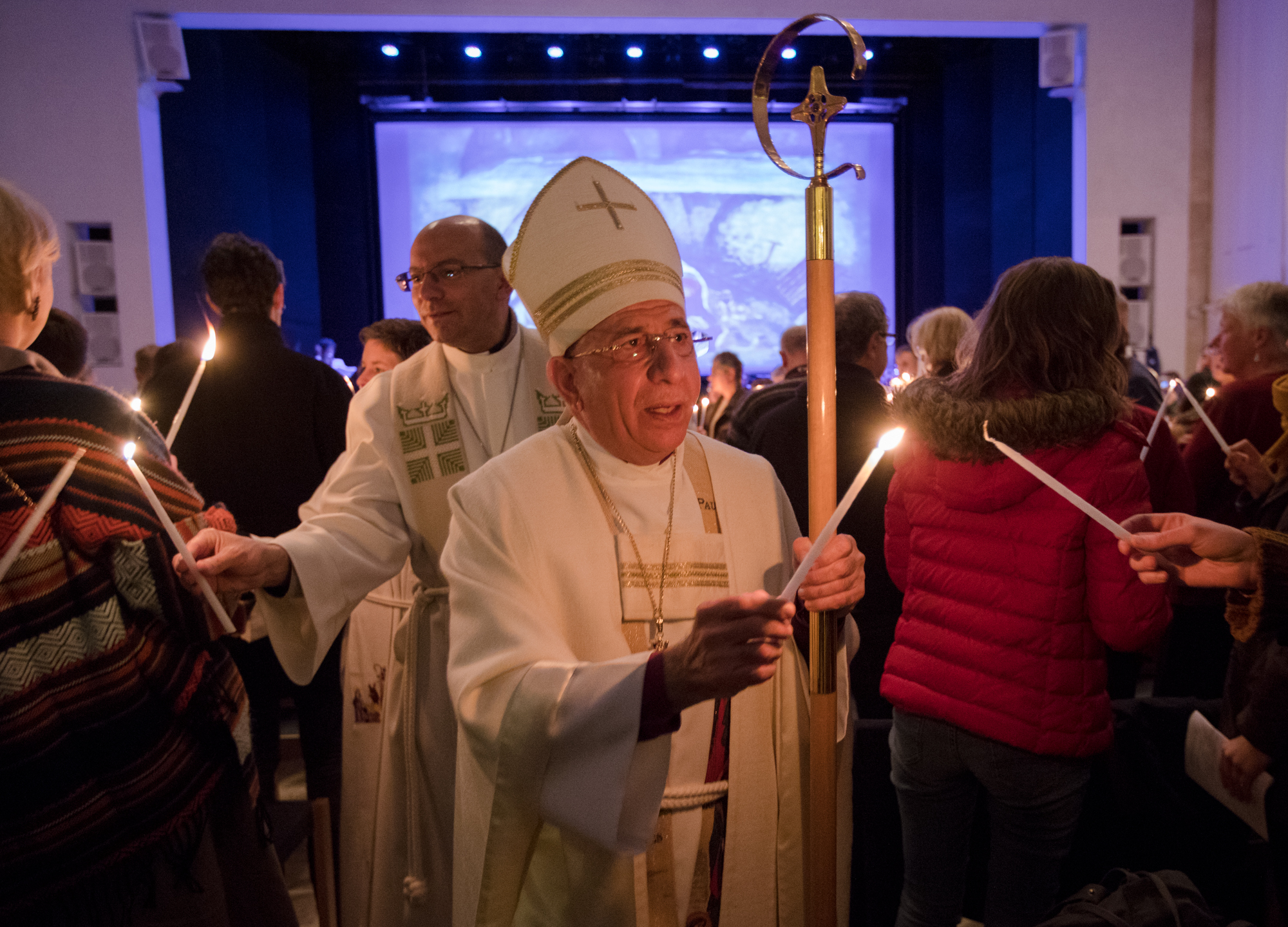 Bishop Dr. Munib Younan lights candles during Christmas service in Bethlehem.