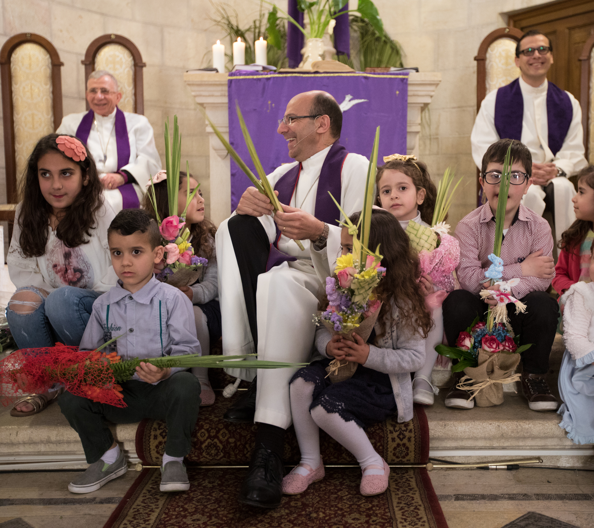Pr. Dr. Mitri Raheb delivers the children's sermon on Palm Sunday in Bethlehem.